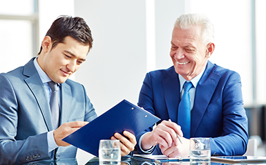 business men looking over report